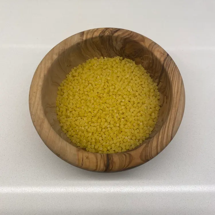 Acini di pepe in a round wooden bowl