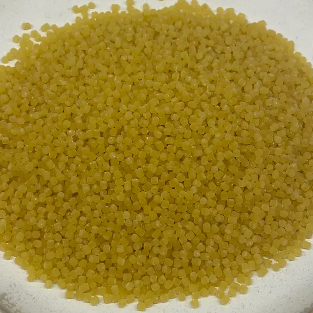 A close up shot of Acini di pepe on a round white plate