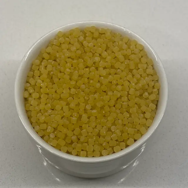 A close up shot of Acini di pepe in a small white bowl