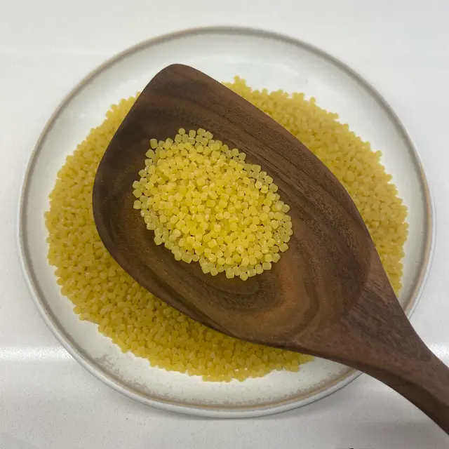 Acini di pepe in a wooden serving spoon