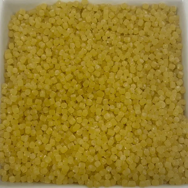 A close up shot of Acini di pepe in a square white glass bowl