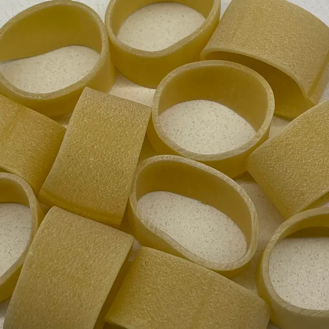 A close up shot of Calamarata on a round white plate