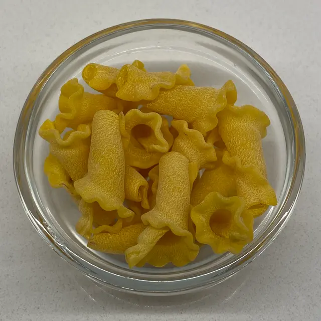 A close up shot of Campanelle in a small round white glass bowl