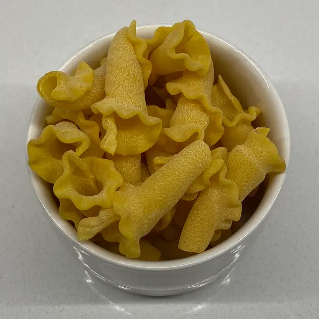 A close up shot of Campanelle in a small white bowl