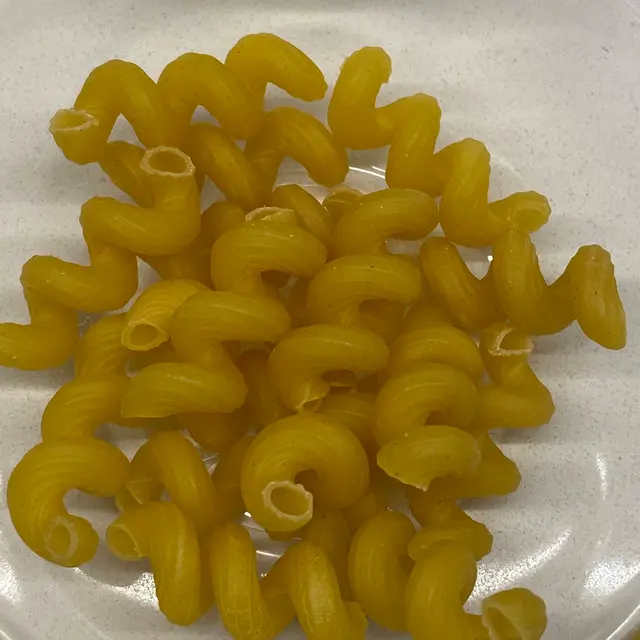 A close up shot of Cavatappi in a clear round glass bowl