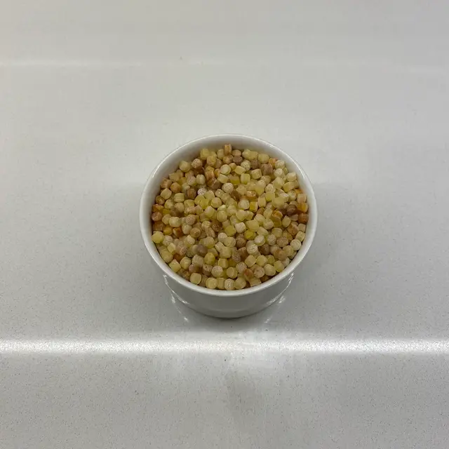 A close up shot of Fregola in a small white bowl