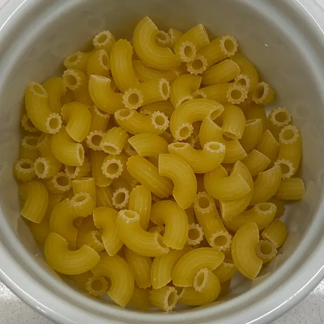 A close up shot of Small Elbow Macaroni in a round white ramekin