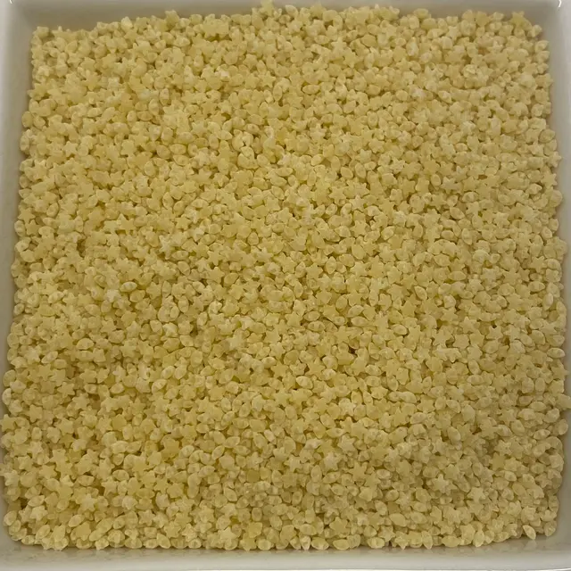 A close up shot of Pastina in a square white glass bowl