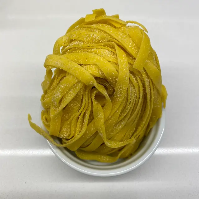 Tagliatelle in a round white ramekin