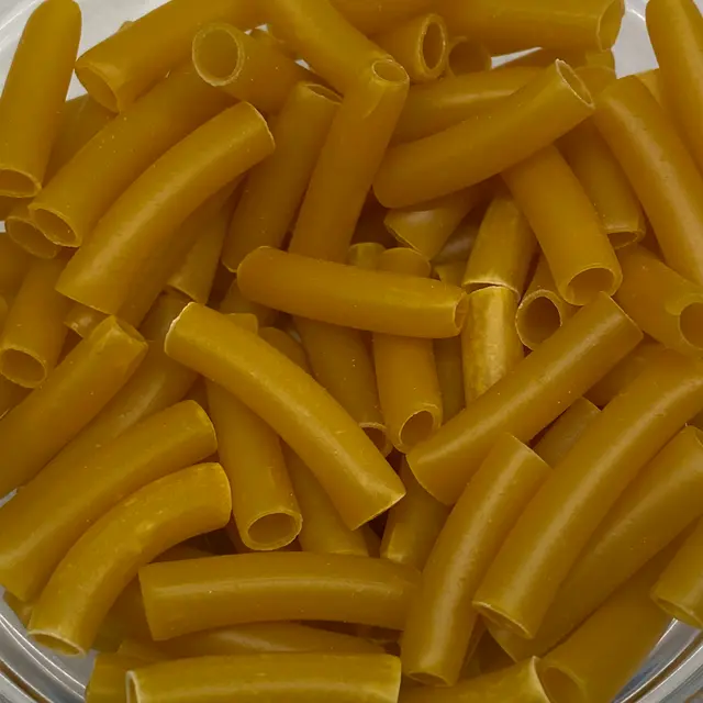 A close up shot of Ziti in a clear round glass bowl