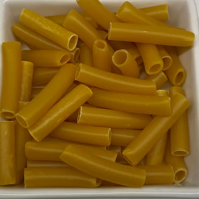 A close up shot of Ziti in a square white glass bowl