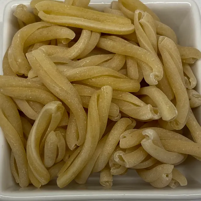 A close up shot of Casarecce in a square white glass bowl